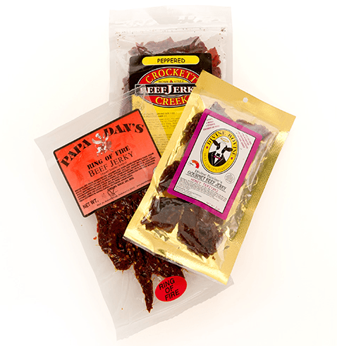 A selection of 3 jerky packets on a white background