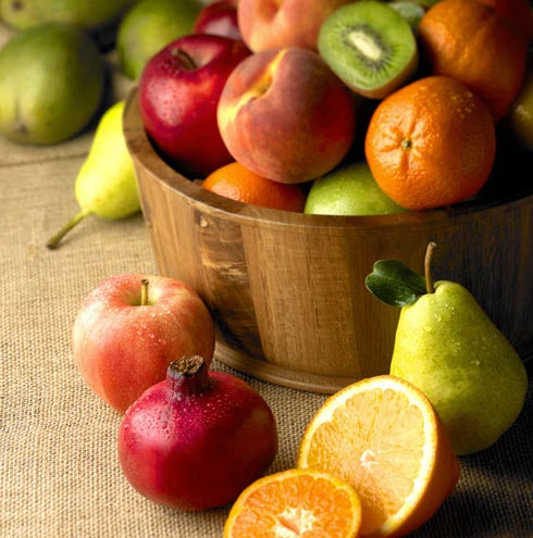 A tub of fruit and fruit on a table