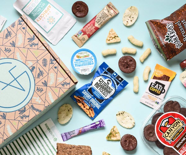 A box next to a selection of open snacks on a blue background