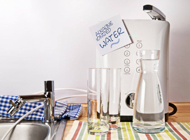 A machine for making ionized alkaline water, next to some bottles of the water