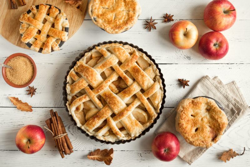 A top down view of apple pie with cinnamon and apples