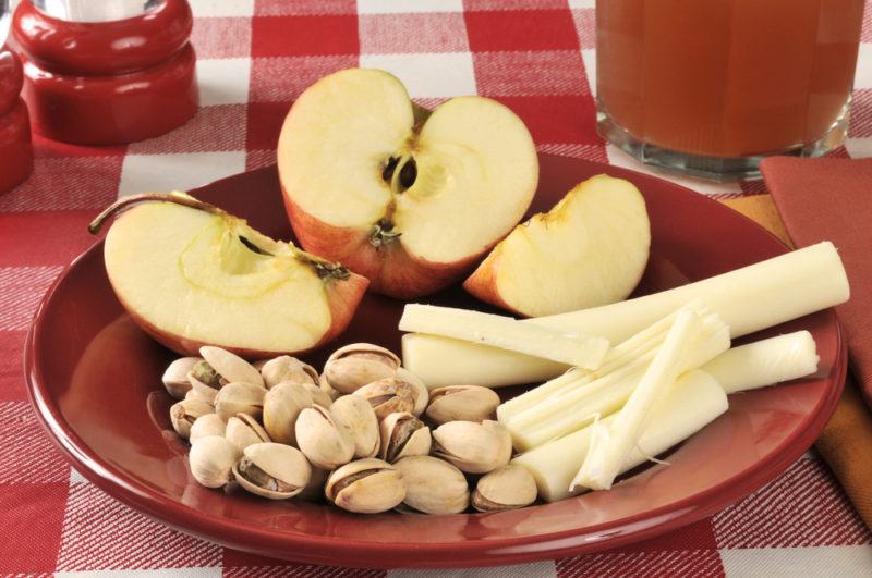 Apple, string cheese and nuts on a plate