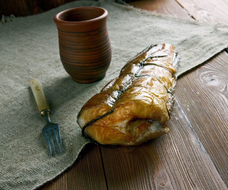 An Arbroath Smokie next to a cup