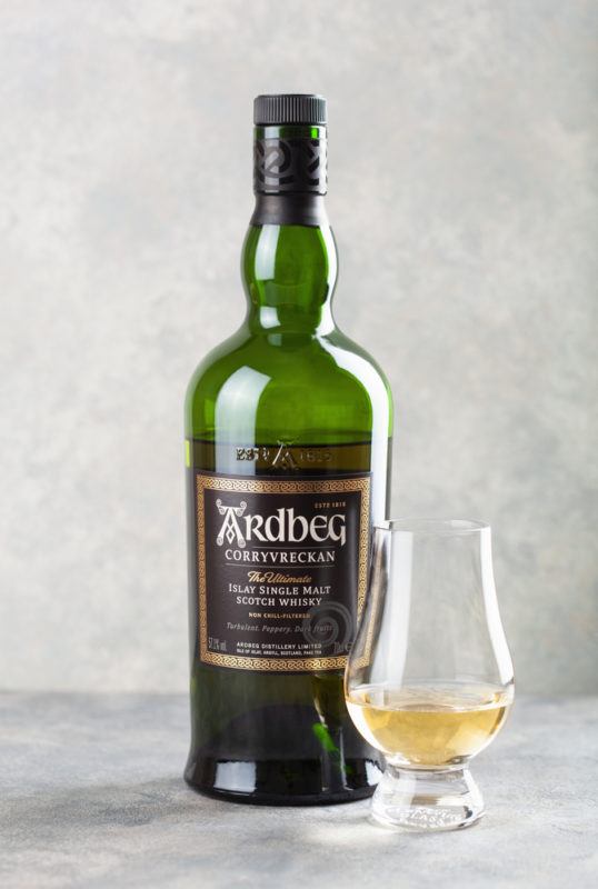 Ardbeg Corryvreckan with pale background and whiskey poured in snifter