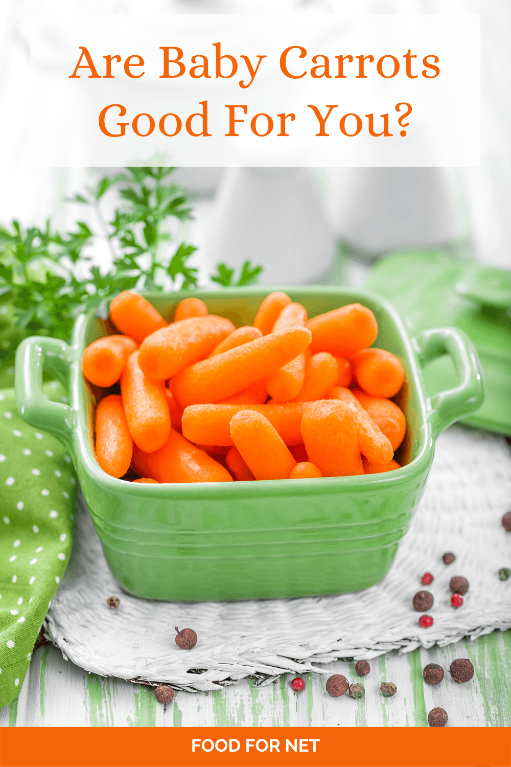 A green dish containing fresh baby carrots, looking at whether baby carrots are good for you