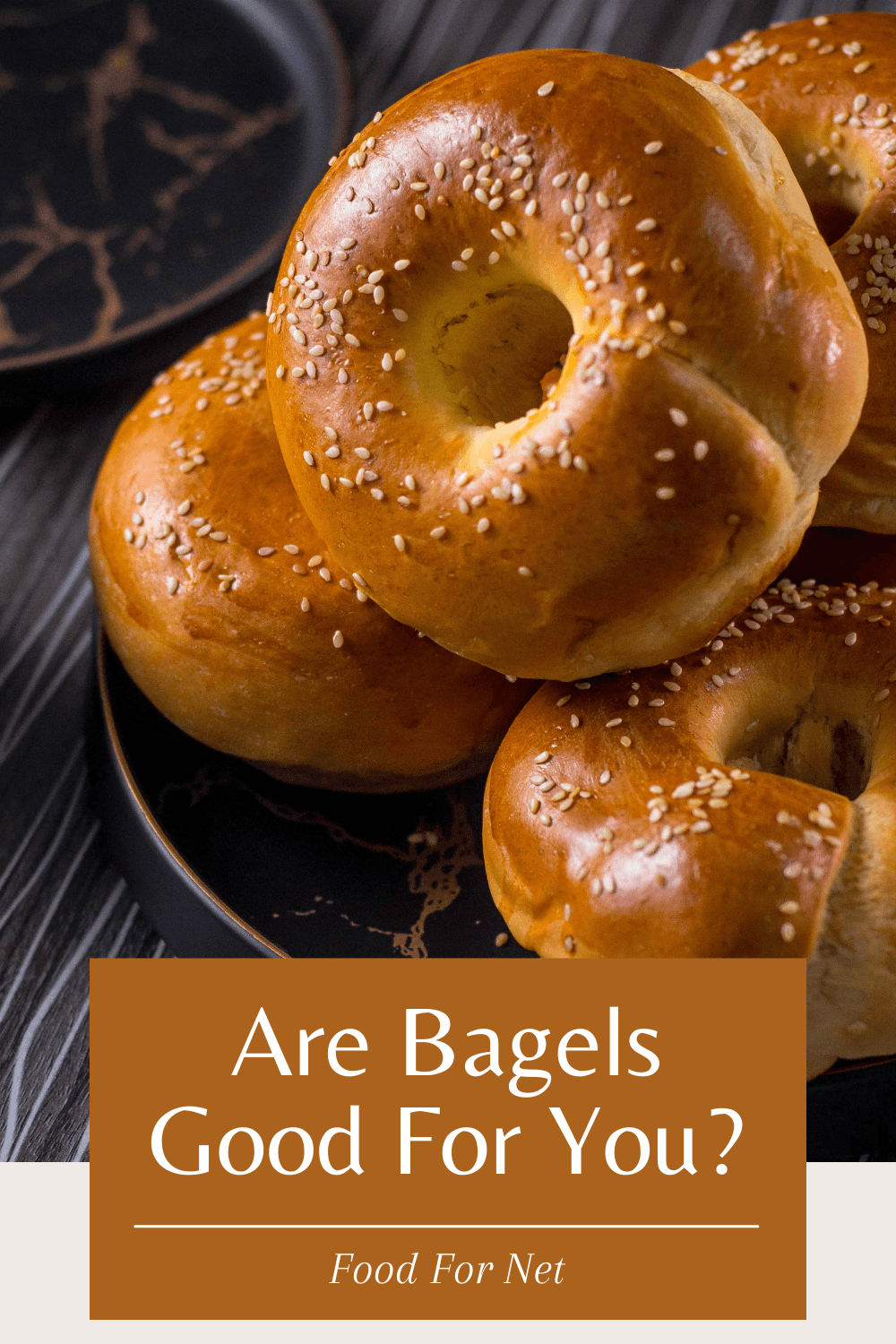 A black dish containing fresh bagels, looking at whether bagels are good for you