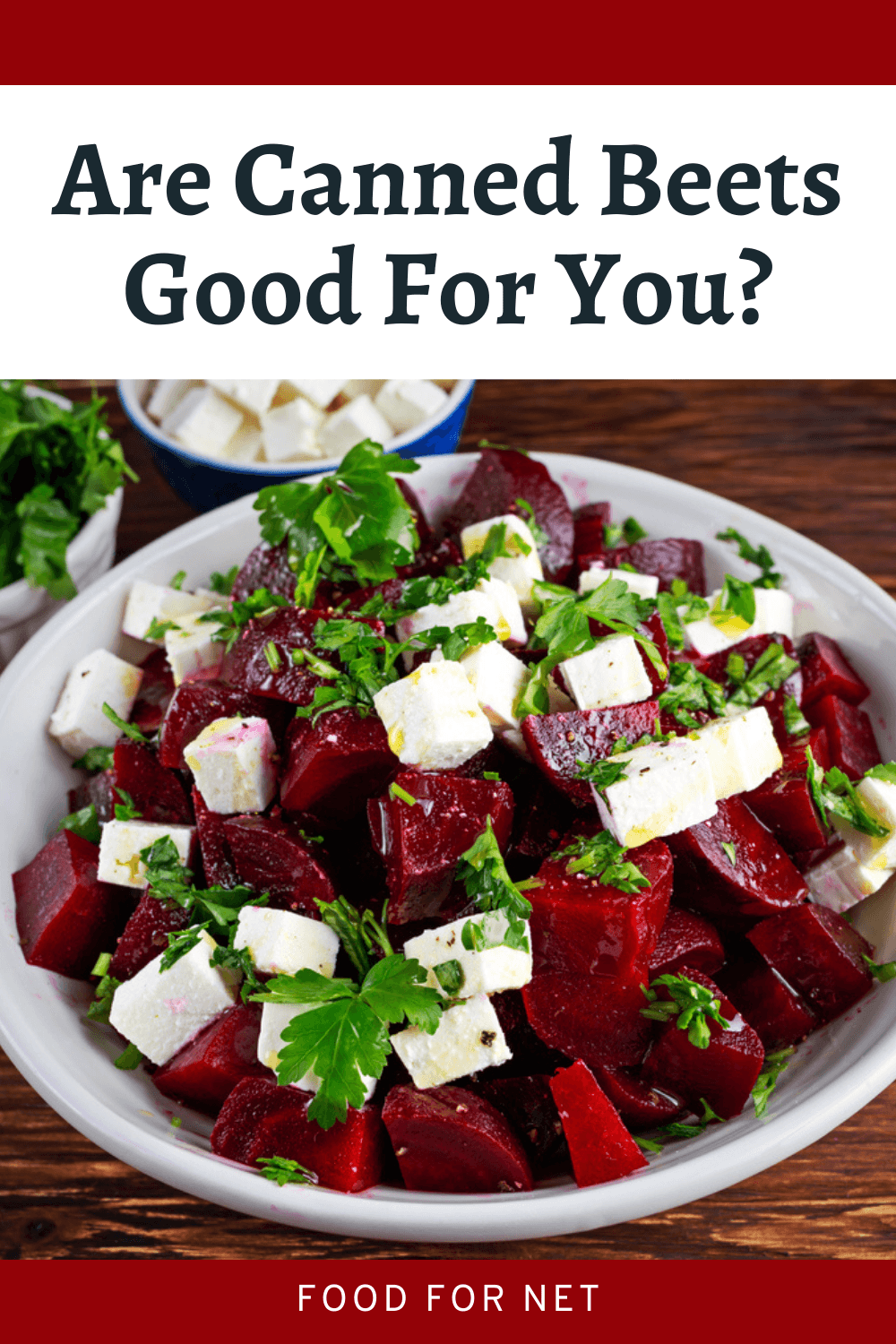 A white dish containing beet chunks, cheese, and parsley, looking at whether canned beets are good for you