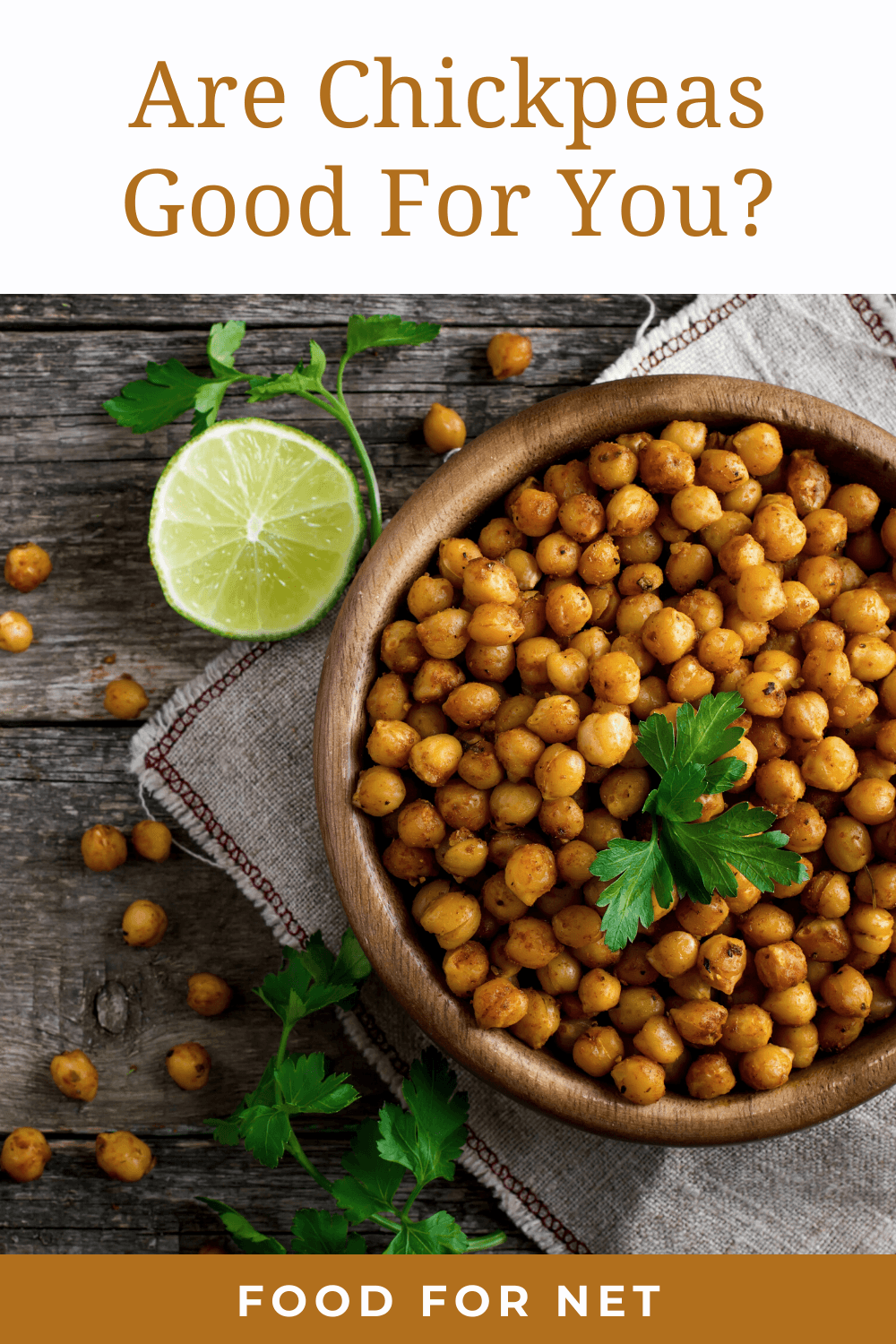 Are Chickpeas Good For You? A large wooden bowl containing roasted chickpeas next to half a lime