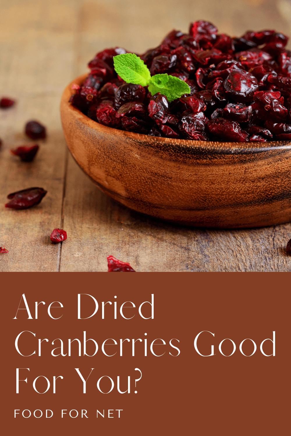 A brown bowl of dried cranberries on wooden boards, highlighting the question of whether dried cranberries are good for you