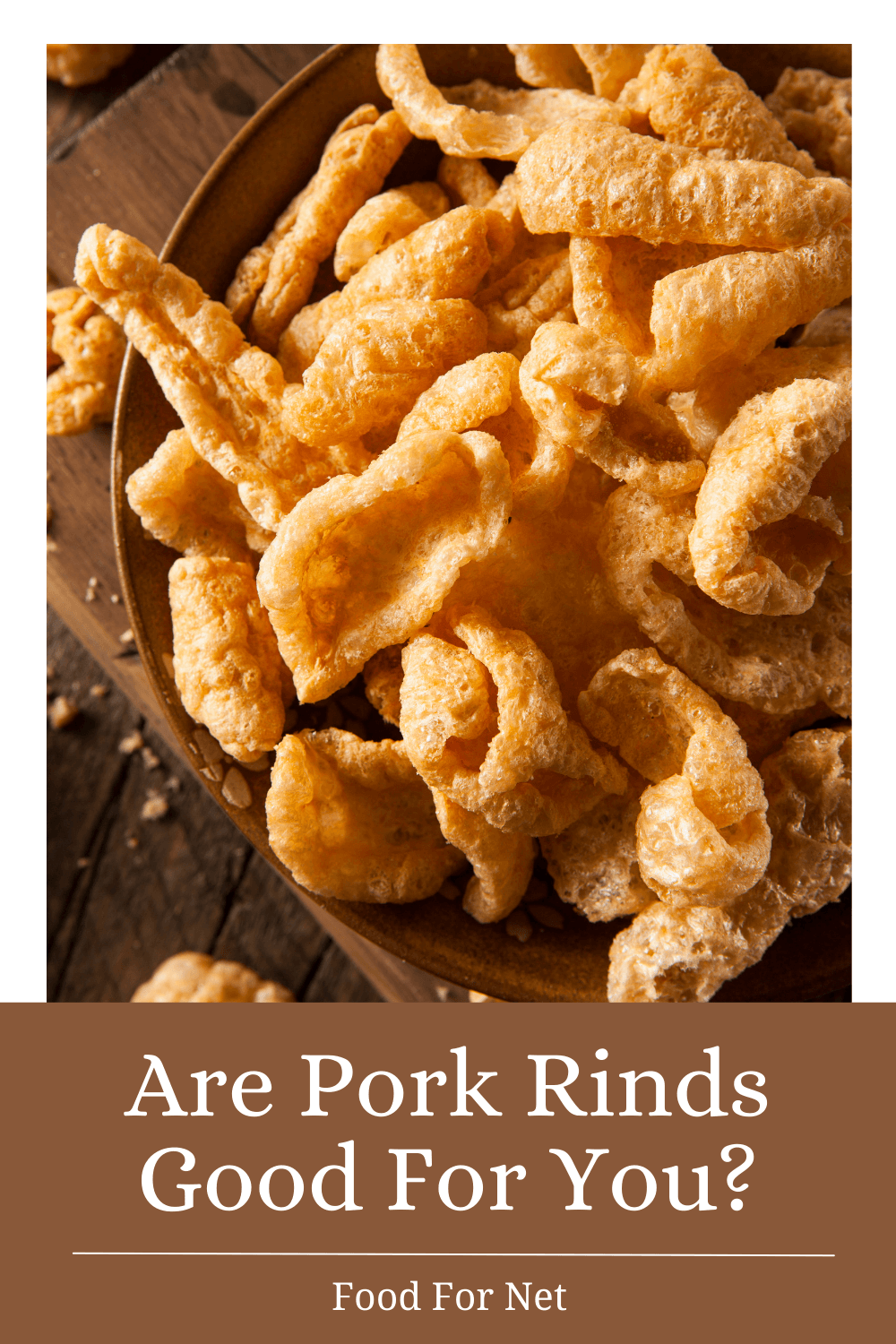 A wooden bowl containing pork rinds, looking at whether pork rinds are good for you