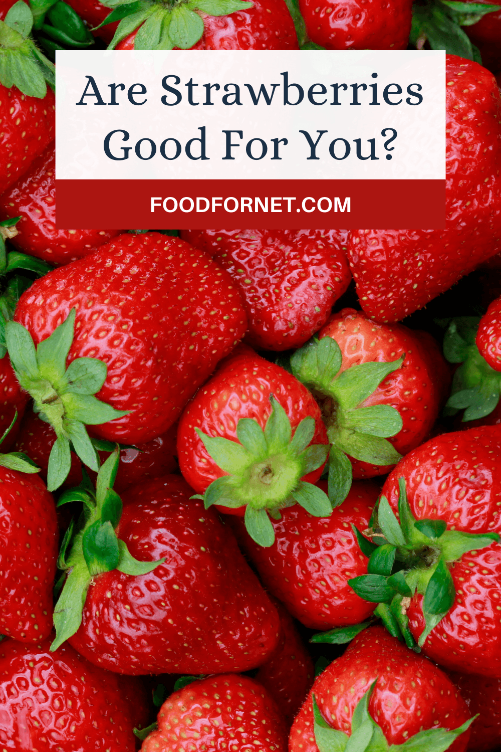 A pile of strawberries on a table, looking at whether they're good for you or not