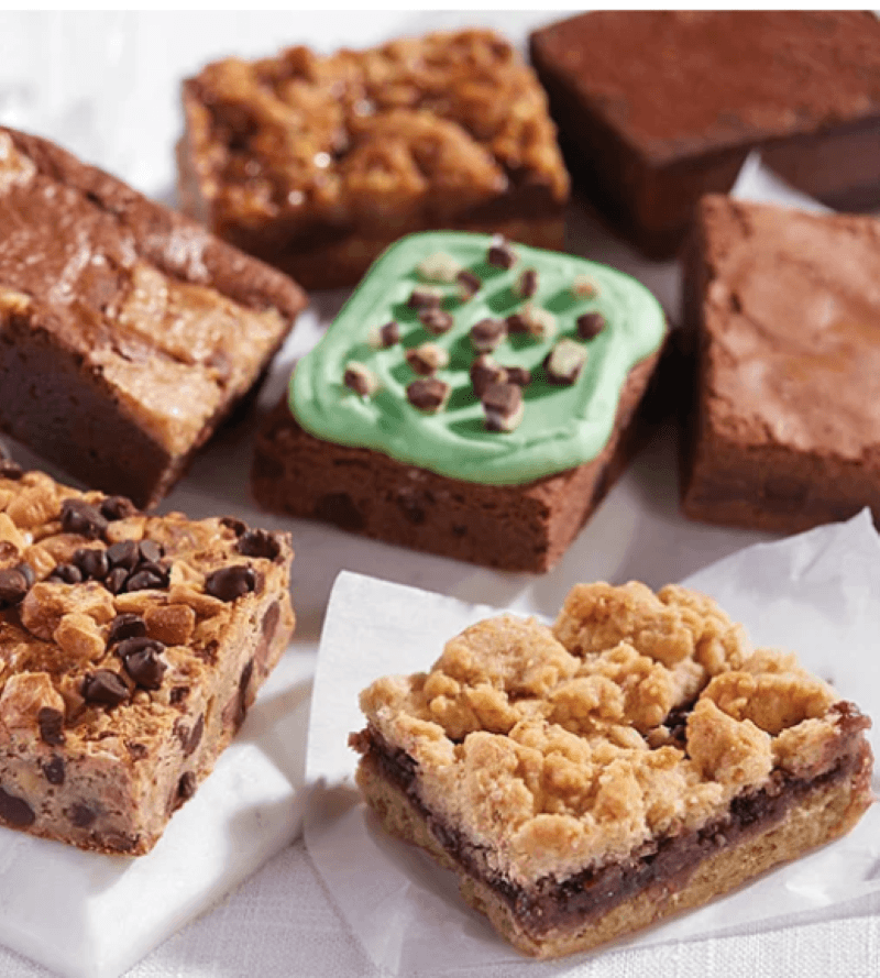 A variety of 7 brownies including flavors like chocolate mint, peanut butter, caramel and chocolate