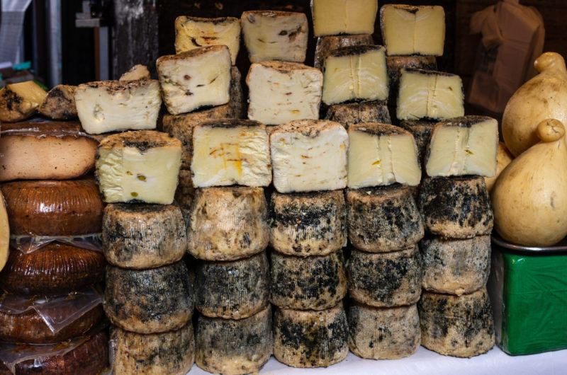 Assortment of aged cheese for sale at La Pescheria market in Catania, Italy