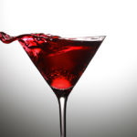An Aunt Roberta cocktail in a martini glass against a white lit background