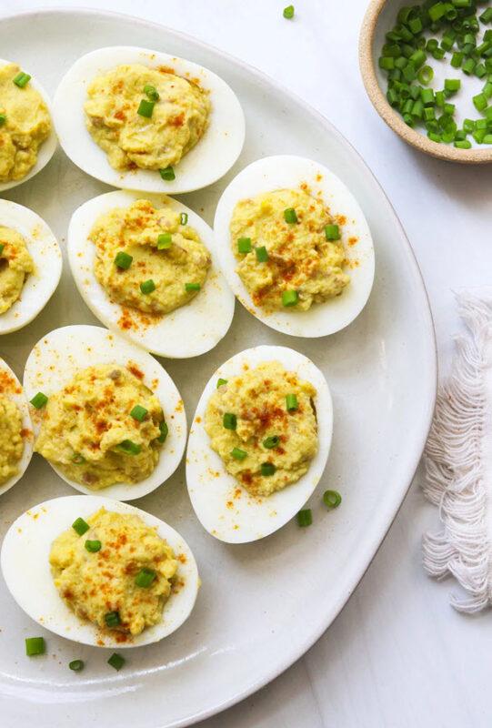 A white plate with a selection of avocado deviled eggs