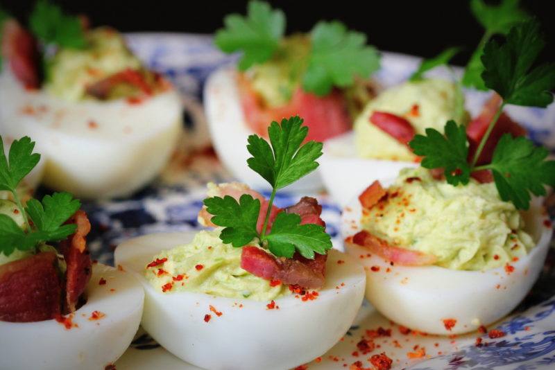 Sliced stuffed eggs with avocado