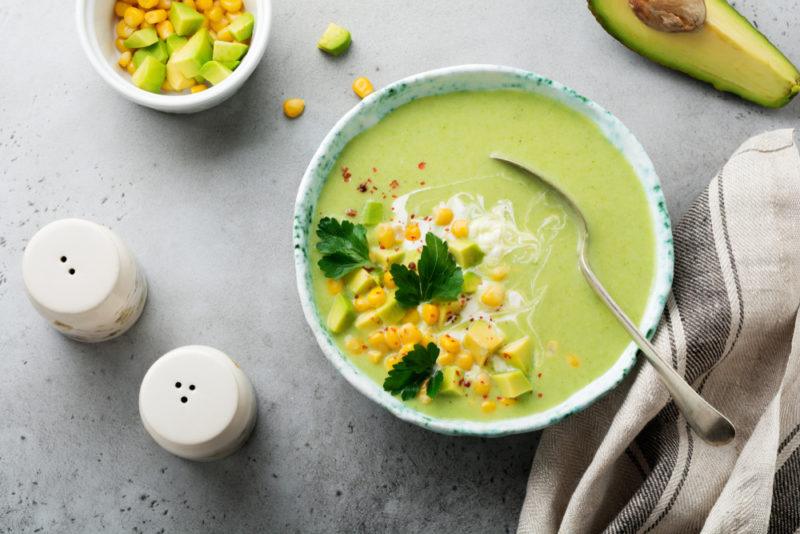 A bowl of avocado soup with garnishes