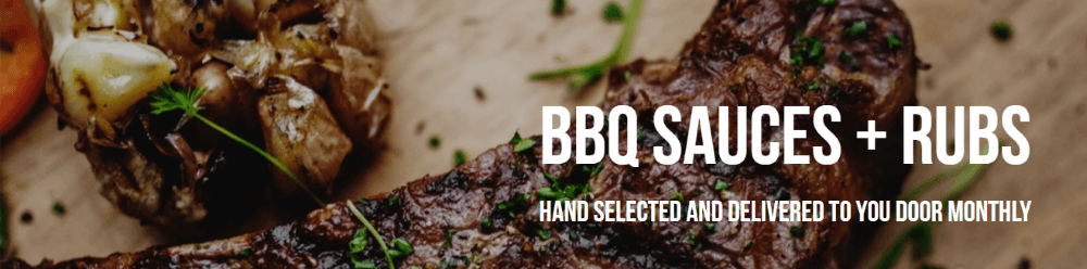 Photo of a grilled steak sprinkled with parsley.  Upper left corner grilled garlic bulb.  Both sitting on a wooden cutting board.  On the right side it states in white font, "BBQ sauces + rubs, hand selected and delivered to your door monthly