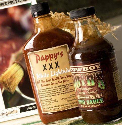 2 bottles of BBQ sauce in front of a computer monitor