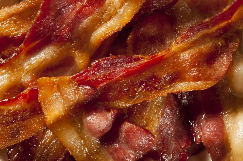 This photo shows a closeup of cooked bacon.