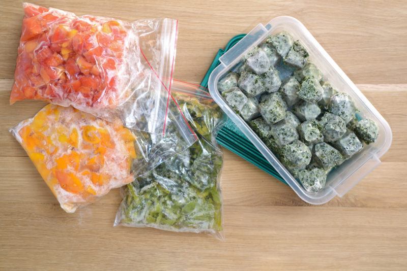 Bags and a container of frozen veggies