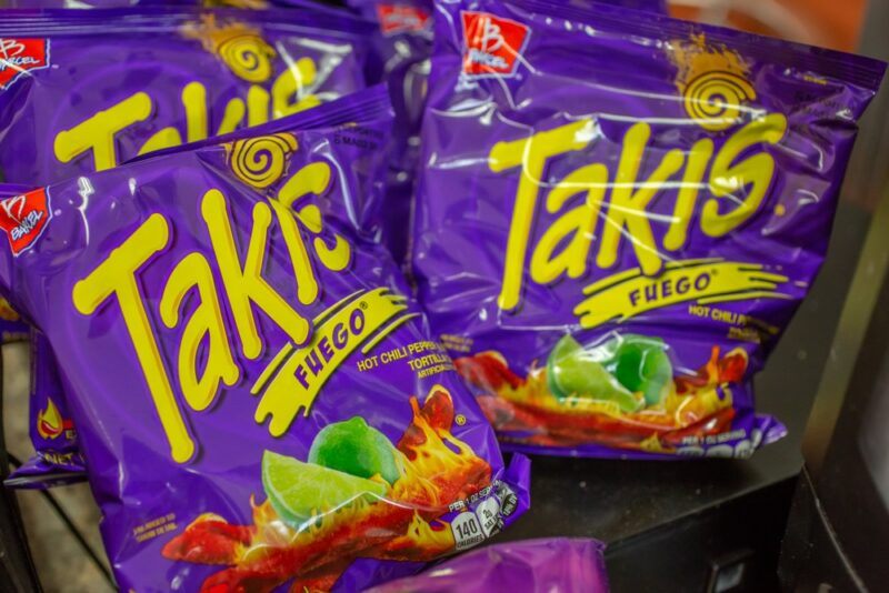 Purple bags of Takis on a store shelf