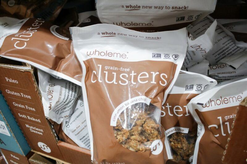 Brown and white bags of granola clusters in a grocery store