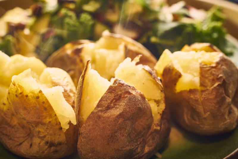 A few baked potatoes on a table