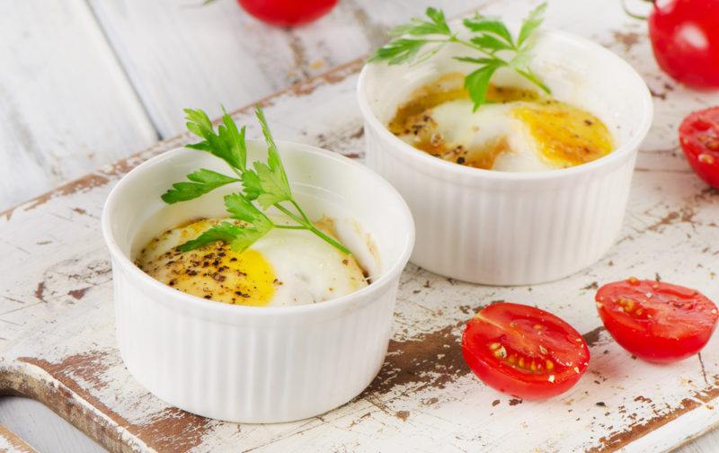 Two ramekins containing baked eggs