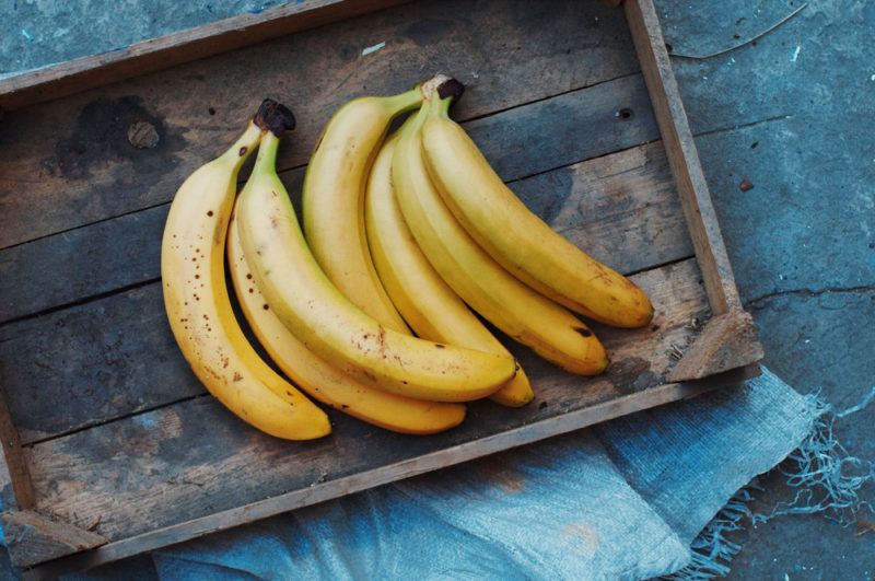 Ripe bananas on a wooden tray