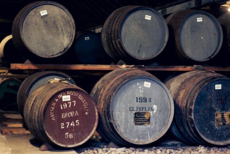 Barrels of whiskey aging, including Brora whiskey