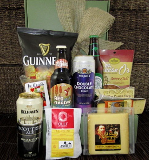 Various bottles and cans of beer, along with snacks and cheese, against a green box.