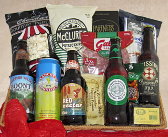 A top down image showing bottles and one can of beer, along with snacks like popcorn, salami and nuts.