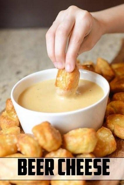 Hand dipping snacks into a beer cheese dip