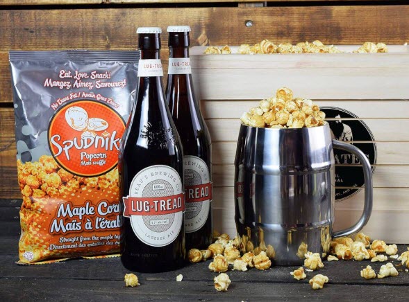 A bag of maple corn, 2 bottles of beer and a insulated beer keg mug. 