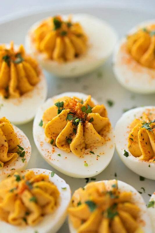 A collection of deviled eggs with darker yolks than normal