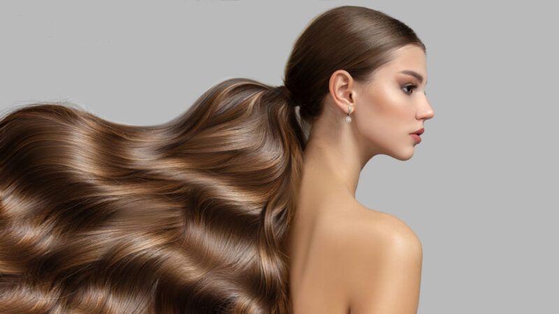 Wavy,Long,Thick,Hair,Womens,Fashion.,Hair,Care | Food For Net This photo shows a side photo of a beautiful brunette woman, with her healthy, shiny hair streaming out behind her, representing the best foods for your hair.