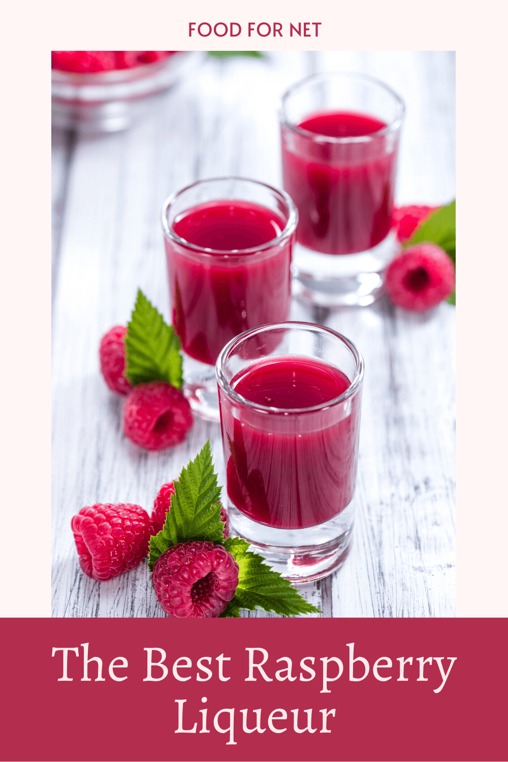 Best Raspberry Liqueur. A selection of small shot glasses filled with raspberry liqueur on a white wooden table