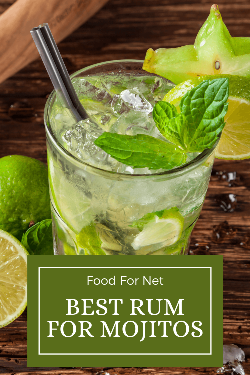 A mojito made with rum on a wooden table next to limes and a juicer