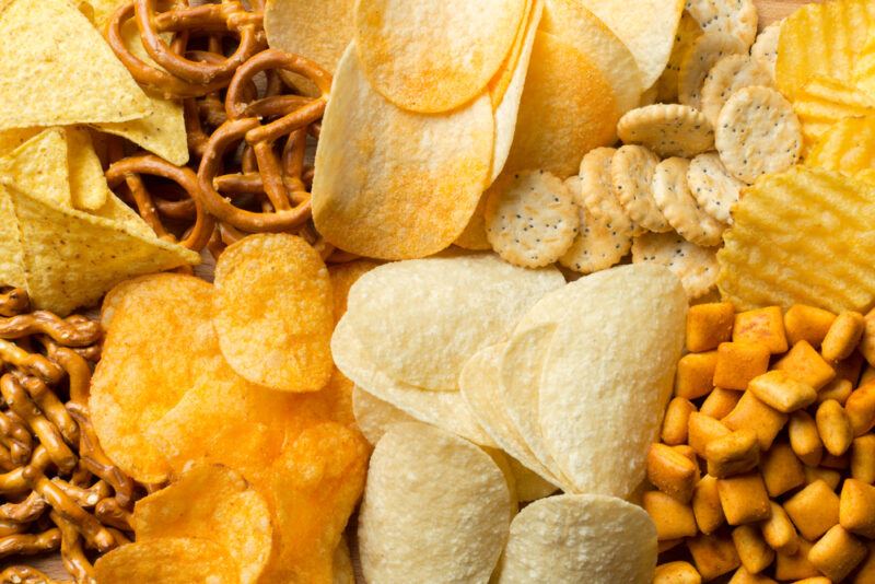 Salty,Snacks.,Pretzels,,Chips,,Crackers | Food For Net This photo is an overhead view of a mix of several snack foods, including crackers, pretzels, and chips, representing the best snack foods for party people.