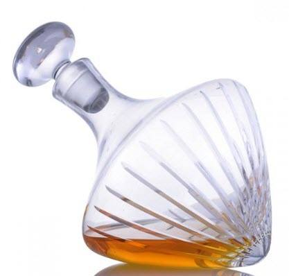 Beveled Orbital Magnum Decanter | Food For Net A tilted decanter with whiskey