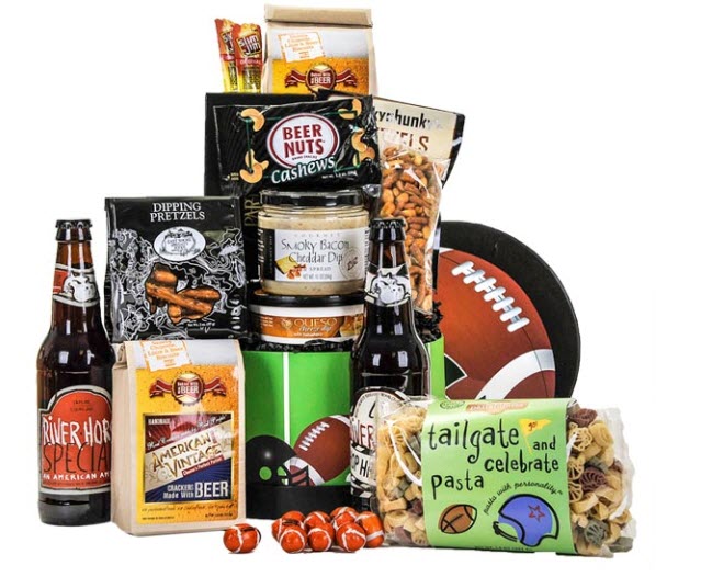 A pyramid of items including various football-themed snacks and two bottles of beer. 