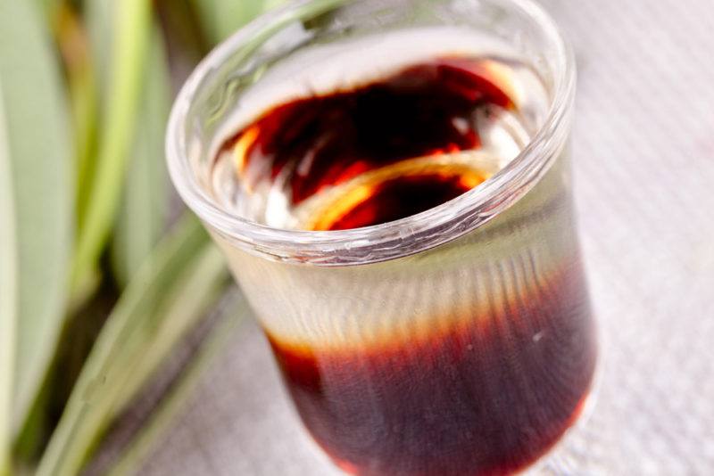 A close up image of a black Russian cocktail in a shot glass