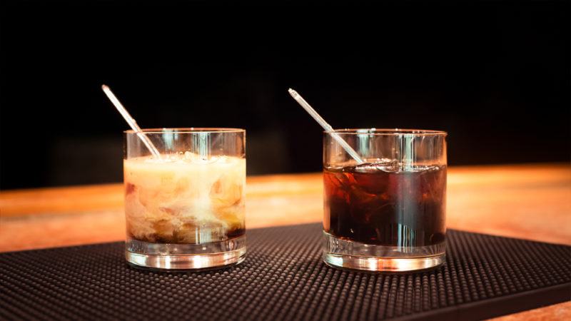 Black Russian and White Russian cocktails on a table