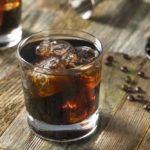 A black Russian cocktail on a wooden table