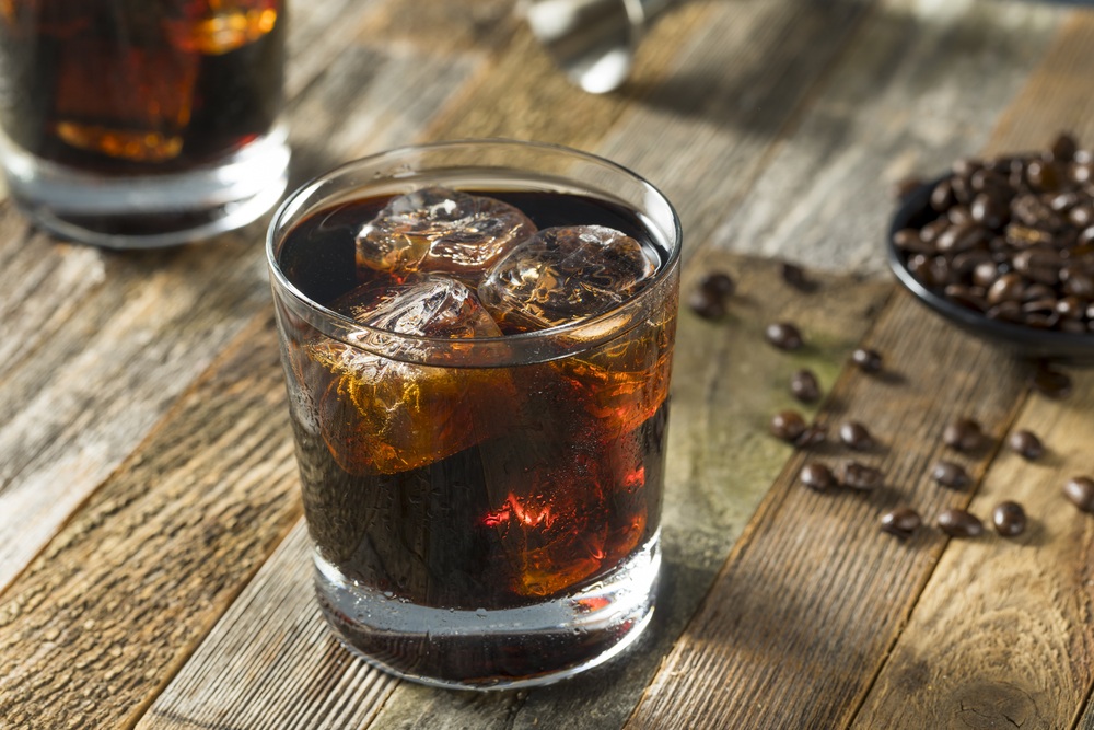 A black Russian cocktail on a wooden table