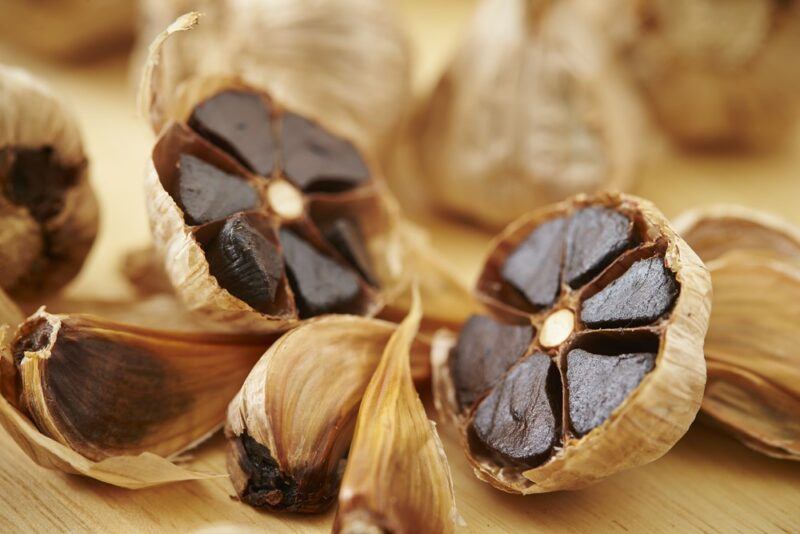 Black fermented garlic that has been sliced and will be used in cookies