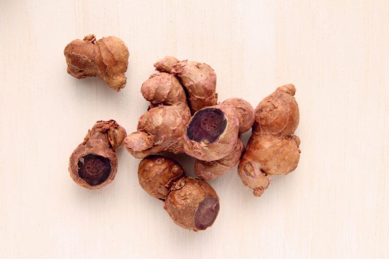 Pieces of black turmeric isolated on a white background