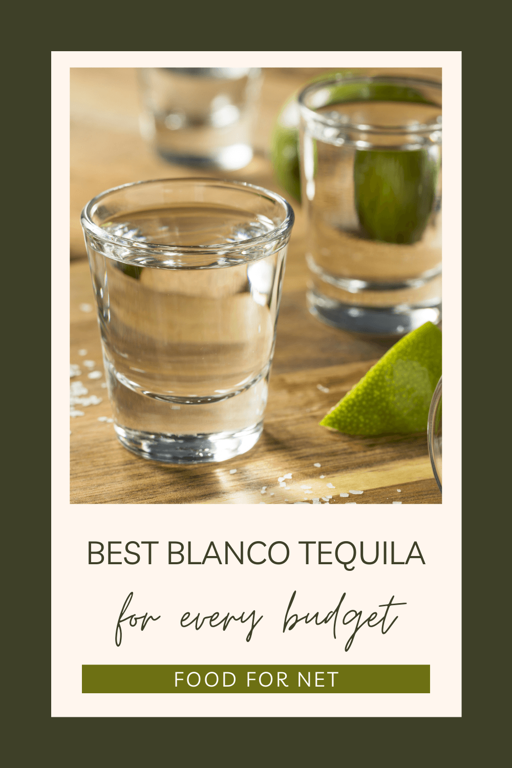 Shot glasses with blanco tequila next to lime wedges