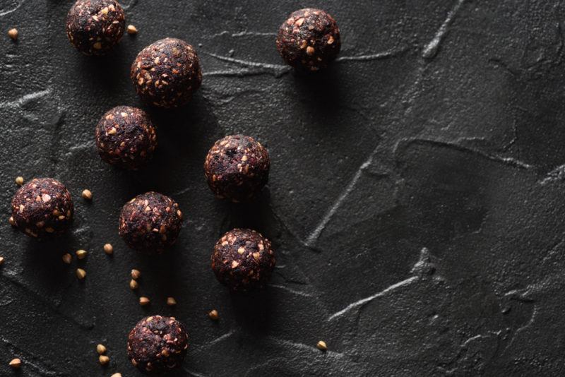 A black dish with small homemade bliss balls